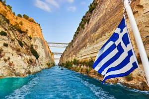 Canal between two cliffs and Greece flag