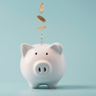 Piggy bank with coins falling into it