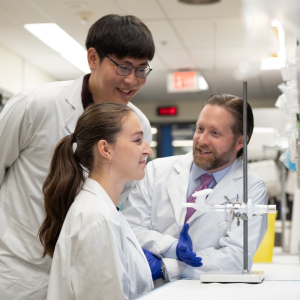 image of people looking and smiling in a lab.